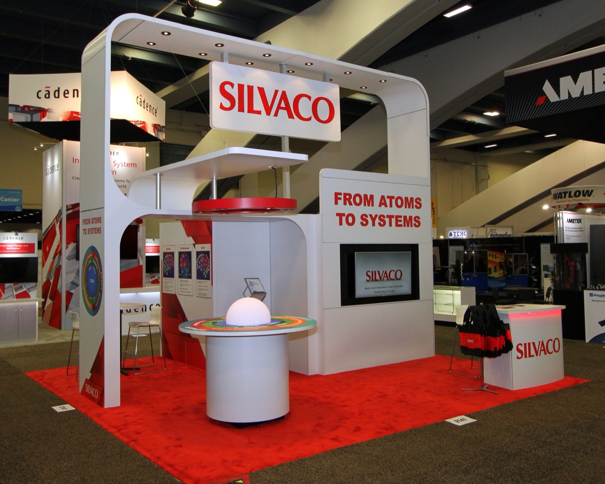 Silvaco booth with branded header arch and demo kiosks, built by Art & Display